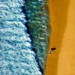 surfer at shoreline