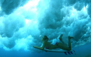 Surfer girl blowing bubbles