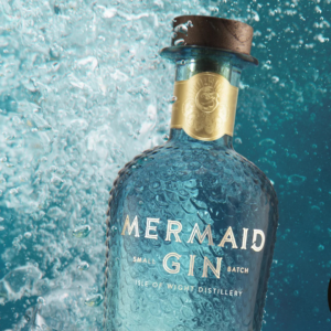 bottle of mermaid gin in the sea