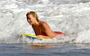Charlize Theron surfing