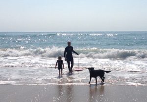 father daughter and dog surfing
